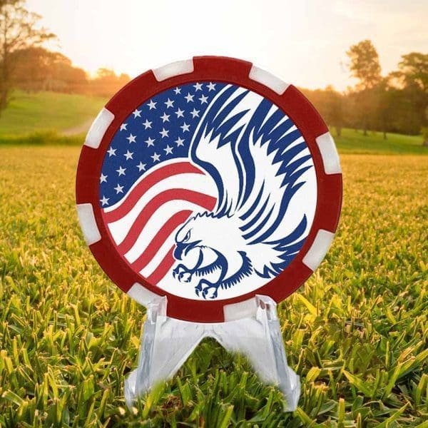 Poker chip style golf ball marker with red and white border, featuring an American flag and stylized eagle against a white background.