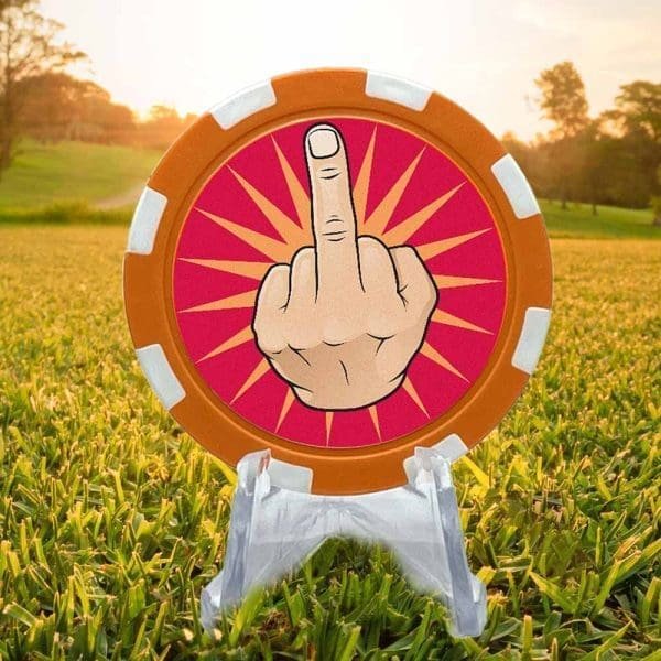 Poker chip style golf ball marker featuring an orange and white border and a cartoon hand with the middle finger up against a red background.