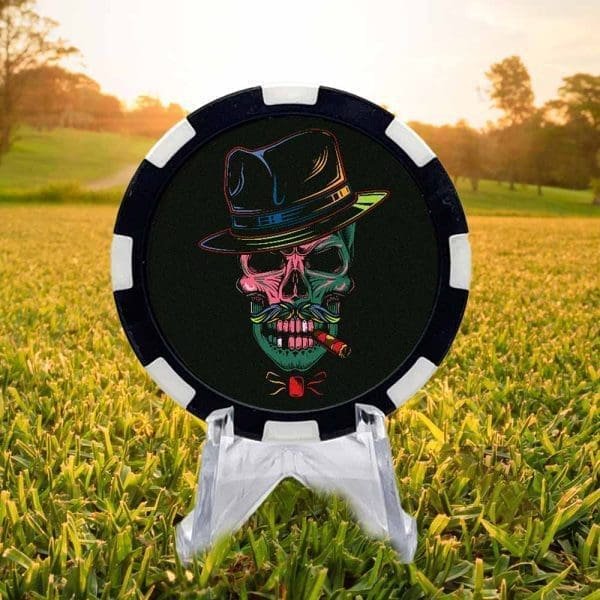 Black and white golf ball marker poker chip featuring a colorful skull with a cigar and fedora against a black background.